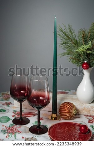 Christmas festive table setting with red decorations and checkered towel on white background. View from above. Copy space. Xmas dinner. Template for festive menu.
