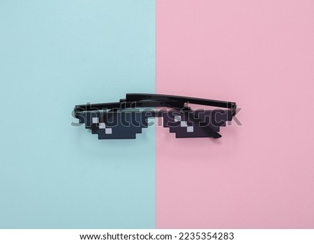 Pixelated 8 bit sunglasses on pastel background