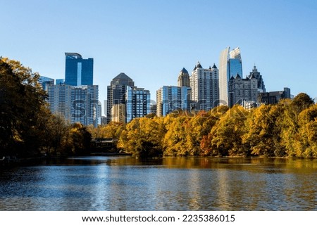 View of a city skyline with a lake in Autumn