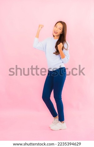 Portrait beautiful young asian woman smile with action on pink isolated background