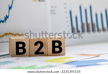 B2B. Business to business transactions. Business to Business. B2B letters drawn on a wooden block. Wooden table background. Royalty-Free Stock Photo #2235395535