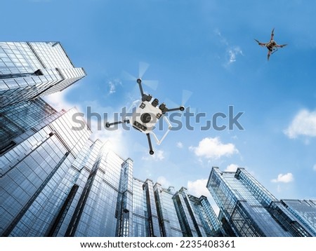 Drones flying amongst buildings also known as unmanned aircraft systems aka UAS. Testing of technologies to safely manage drone traffic. Digitally enhanced. Elements of this image furnished by NASA. Royalty-Free Stock Photo #2235408361