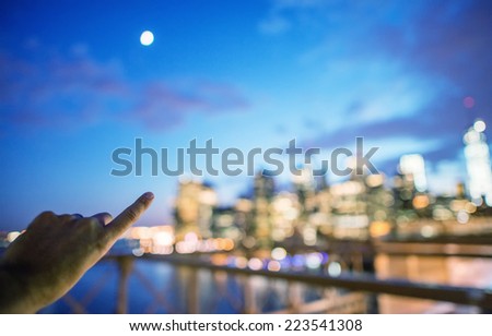 Man at night indicating Lower Manhattan.