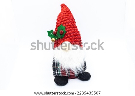 Christmas gnome with red hat on white background.