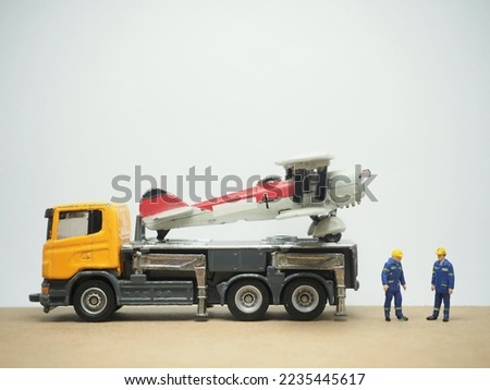 Mini toy at table with white background. Towing truck conceptual design.
