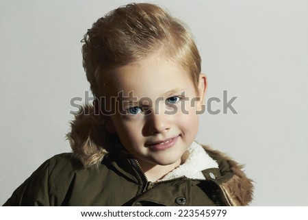 funny Fashionable child in winter coat. fashion kids.children.khaki parka.smiling little boy. hairstyle