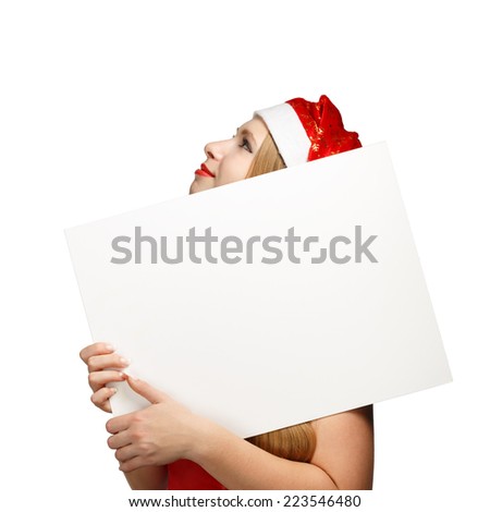 Woman in new year or christmas hat hiding behind the advertisement isolated on white background