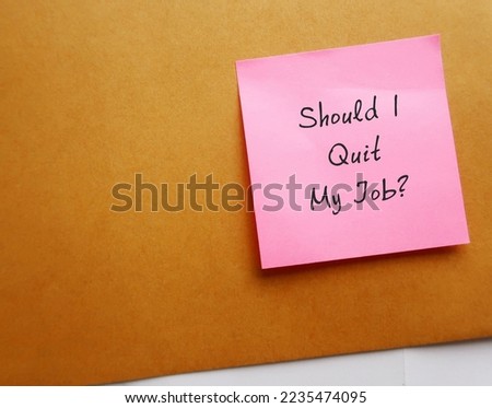 Pink note on office envelope with handwritten text Should I Quit My Job? - concept of employees are considering leaving their jobs in The Great Resignation, decision making to resign or change career Royalty-Free Stock Photo #2235474095