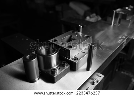 Sheet Metal Stamping Tool Die for Automotive Precision Parts on The Numerical Control Milling Machine Table. Tandem Stamping System. At a High Quality Technology Factory. Black and White Photography. Royalty-Free Stock Photo #2235476257