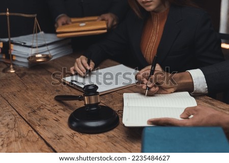 Lawyer discussing with client about contract, agreement, legal guideline, lawsuit. Lawyer work on documents in the office.