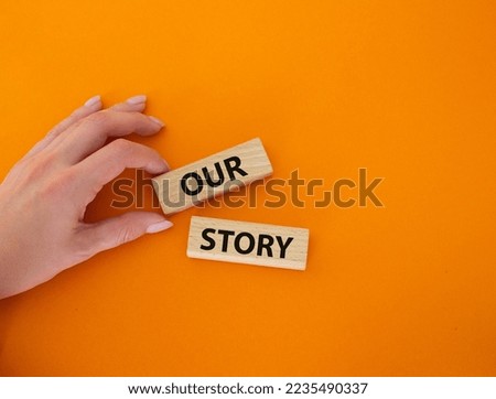 Our story symbol. Wooden blocks with words Our story Beautiful orange background. Businessman hand. Business and Our story concept. Copy space. Royalty-Free Stock Photo #2235490337