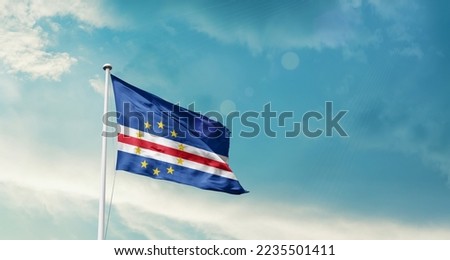 Cape Verde national flag waving in beautiful sky. Royalty-Free Stock Photo #2235501411