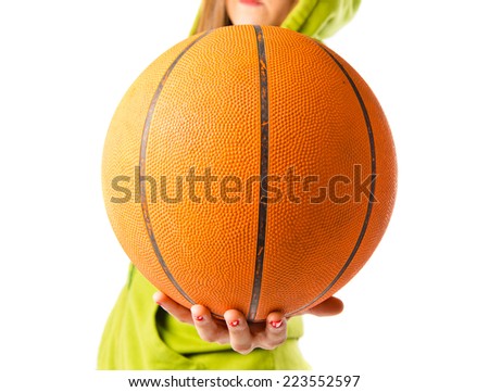 Blonde girl playing basketball over white background