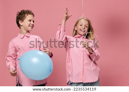 cute, beautiful children, brother and sister, joyfully play with inflatable balloons