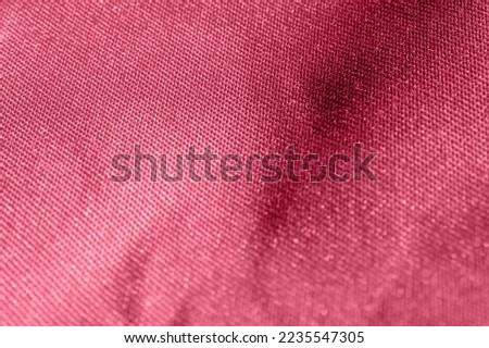 Viva Magenta Colored Texture. Color of the year 2023. Macro. Abstract Pattern of Textile. Close Up. Denim. Background with Textured Material and Polyester Structure. Folded Fabric for Wallpaper.