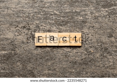 fact word written on wood block. fact text on table, concept.