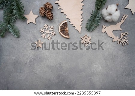 Christmas composition. Christmas decorations, pine cones, fir branches on gray stone background. Flat lay, top view, copy space. Eco Christmas cocept.