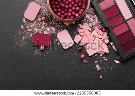 Various makeup products on dark background with copyspace.New 2023 trending PANTONE 18-1750 Viva Magenta colour