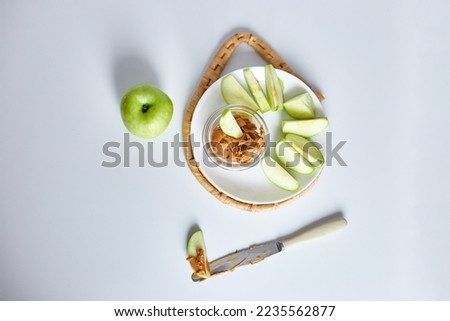 Green slices apples with peanut butter on white background, healthy snack, nutrition food, diet