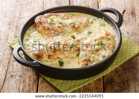 Tasty Mexican Pollo Con Crema Chicken in a creamy sauce with green peppers, onion and garlic closeup in the pan on the wooden table. Horizontal
 Royalty-Free Stock Photo #2235564091