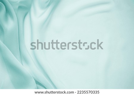 Texture chiffon fabric in olive color for backgrounds. silk fabric. selective focus Royalty-Free Stock Photo #2235570335