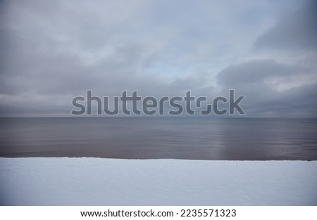 Winter sea coast covered with white snow, selective focus. High quality photo