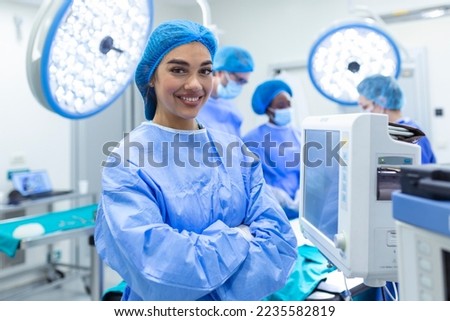 Anesthesiologist keeping track of vital functions of the body during cardiac surgery. Surgeon looking at medical monitor during surgery. Doctor checking monitor for patient health status. Royalty-Free Stock Photo #2235582819