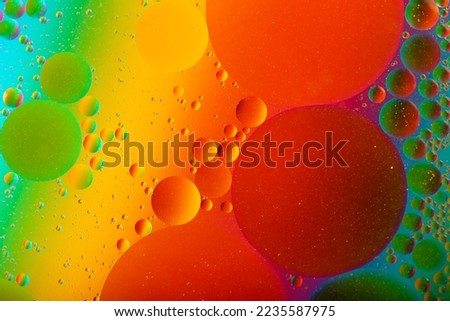 Macro photography of the oil drops on the water surface.Cosmic circles looks like molecule structure.Backdrop with copy space,good as template.