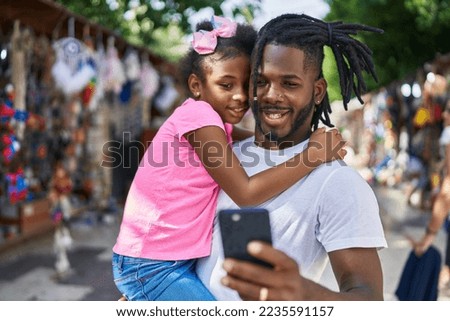 Father and daughter smiling confident make selfie by smartphone at street market