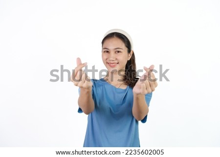Beautiful Asian woman in blue t-shirt isolated on white background. mini heart