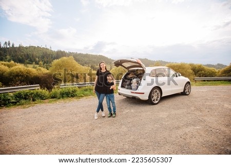 Road trip mith son. Woman with a child in summer clothes in the mountains. Couple of mother with her son on vacation. Single mom on vacation with his boy. Road trip with child	 Royalty-Free Stock Photo #2235605307