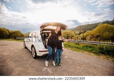 Road trip mith son. Woman with a child in summer clothes in the mountains. Couple of mother with her son on vacation. Single mom on vacation with his boy. Road trip with child	 Royalty-Free Stock Photo #2235605309