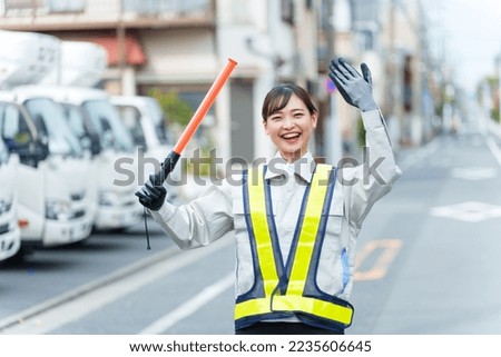 female security guard working traffic control