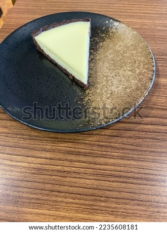 Picture Of a cheesecake slice oN a plate at a cafe in jakarta