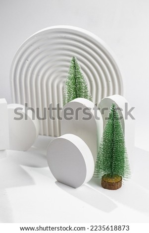 White props for product photography on white seamless background - half-circles, oval doors, rippled arch, zig-zag stairs and small fake christmas tree ornaments