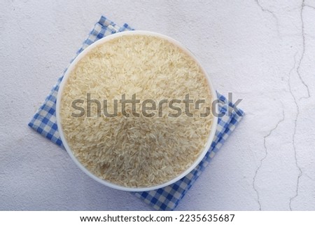 White rice in the bowl on tile background  Royalty-Free Stock Photo #2235635687