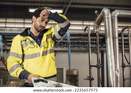 tired engineer worker hard work fatigue male staff in factory hot weather  Royalty-Free Stock Photo #2235657975