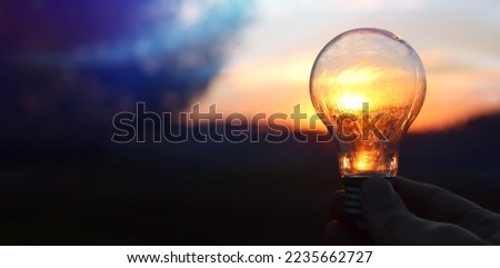 energy and business concept image. Creative idea and innovation. light bulb metaphor in front of the sun
