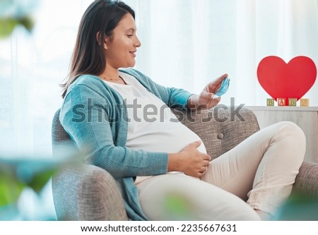 Pregnant woman, ultrasound and mother on sofa in home looking at picture. Pregnancy, sonography and happy female in house with photograph, sonogram and love, care and affection for baby in stomach.