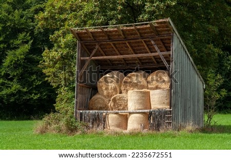 View of an old wooden barn with hay bales in South Bavaria