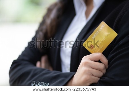 Young attractive asian woman portrait standing holding credit card.