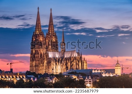 Distant view of the city of Cologne at evening after sunset with the cathedral as an architectural dominant. Real estate and urban life in Germany. Royalty-Free Stock Photo #2235687979
