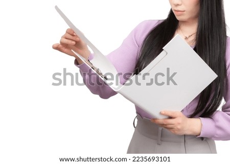 A woman checking a file.