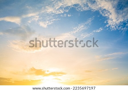 Beautiful Vivid sky painted by the sun leaving bright golden shades.Dense clouds in twilight sky in winter evening.Image of cloud sky on evening time.Evening Vivid sky with clouds