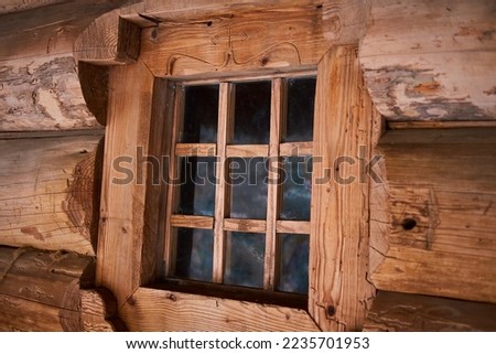 Ancient window in a wooden house.