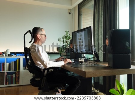 Middle age man working on computer at home. Royalty-Free Stock Photo #2235703803