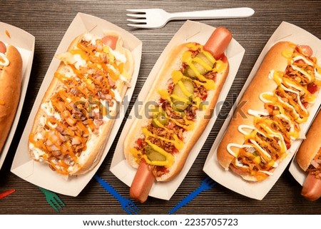 A string of delicious hot dogs from different recipes in paper gondolas