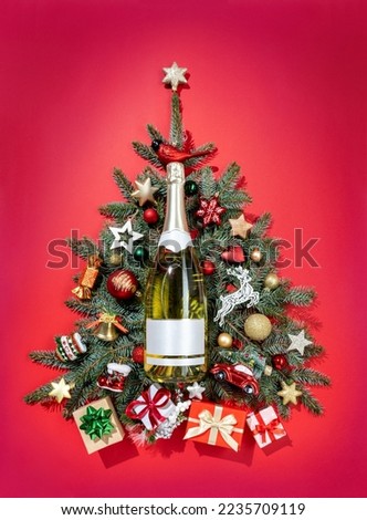 Christmas fir-tree branches with decoration toys and champagne. Merry Christmas and Happy New Year concept