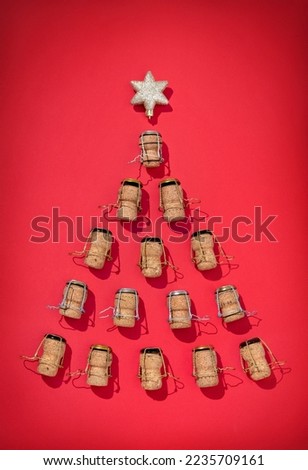 Silhouette of Christmas tree made from champagne corks on red background. Merry Christmas and Happy New Year concept