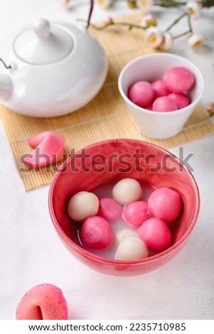 Bowls of tasty tangyuan on white background, closeup. Dongzhi Festival